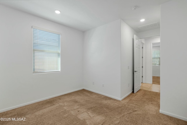 carpeted empty room with plenty of natural light