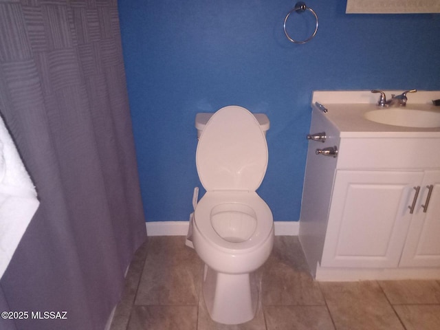 bathroom featuring toilet, vanity, and tile patterned flooring