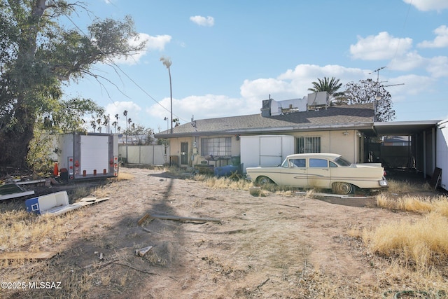 back of property featuring a carport