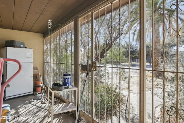 unfurnished sunroom featuring plenty of natural light and wood ceiling