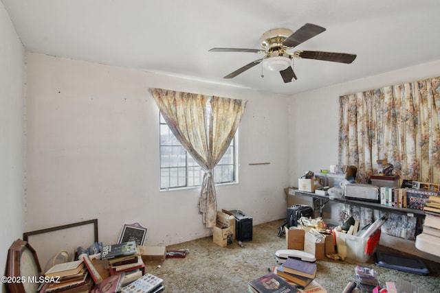 misc room with carpet and ceiling fan