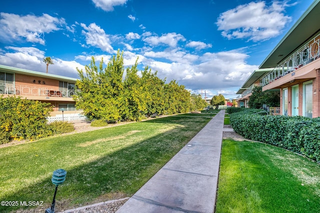 view of home's community featuring a lawn