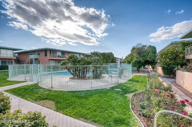 surrounding community featuring a lawn, a patio area, and a pool