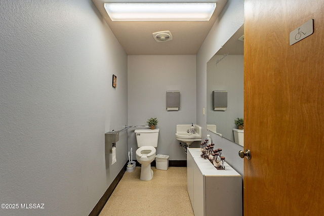 bathroom featuring toilet and sink