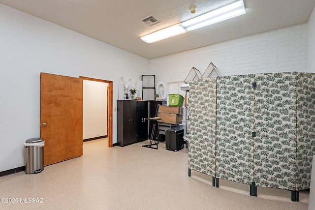 miscellaneous room with brick wall