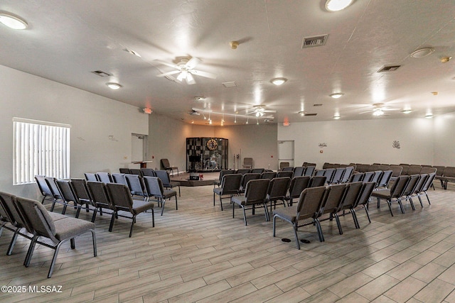 interior space with ceiling fan