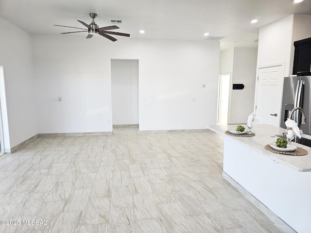 unfurnished living room with ceiling fan