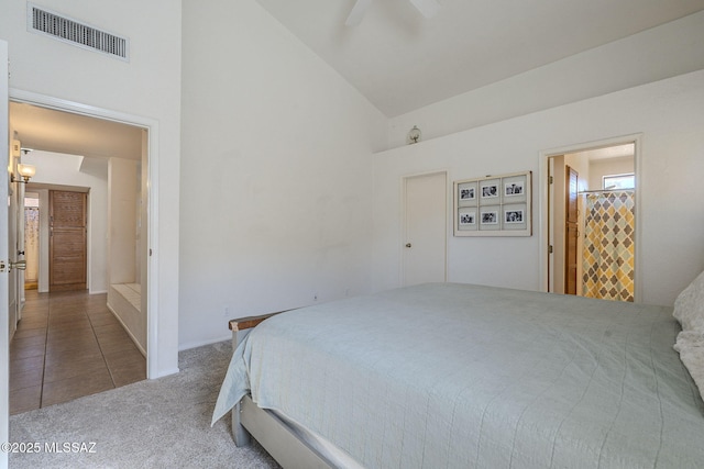 carpeted bedroom featuring ensuite bath, high vaulted ceiling, and ceiling fan