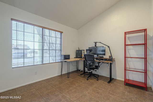 office with tile patterned flooring and vaulted ceiling