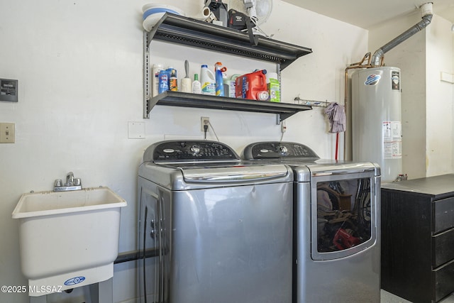 washroom with gas water heater, sink, and independent washer and dryer