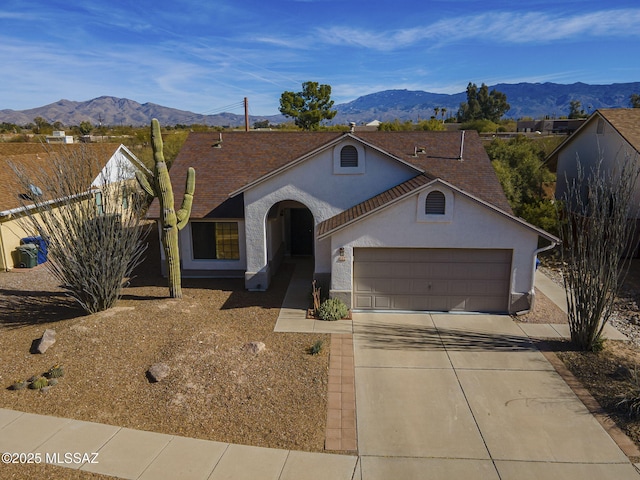 ranch-style home with a mountain view and a garage