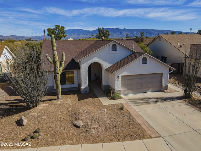 ranch-style home with a mountain view and a garage