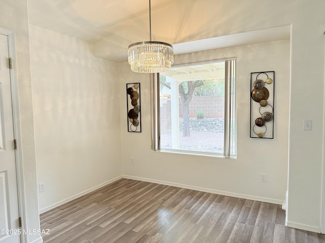 interior space with light wood-type flooring and a notable chandelier