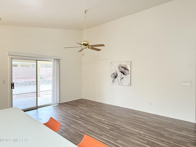 interior space with dark hardwood / wood-style floors, vaulted ceiling, and ceiling fan