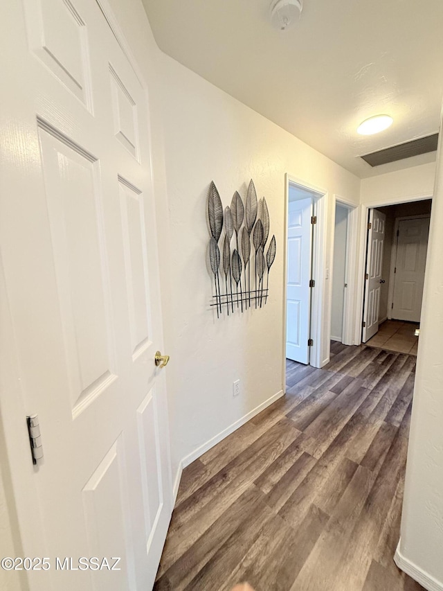 corridor with dark hardwood / wood-style floors