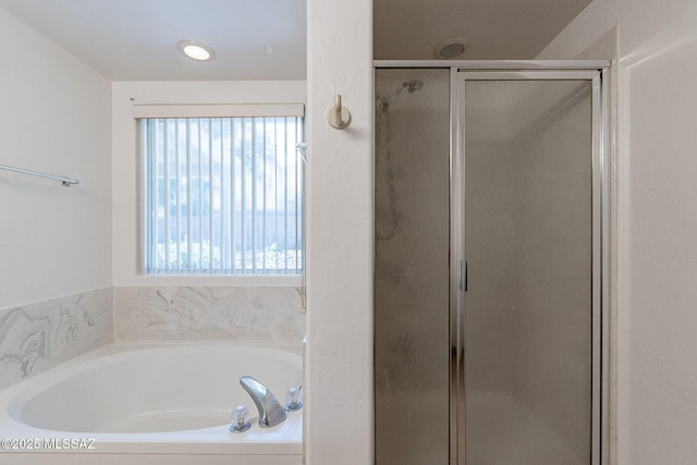 bathroom with shower with separate bathtub