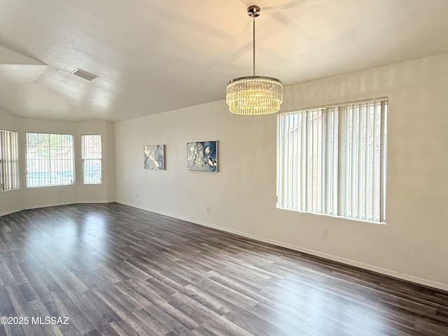 unfurnished room with dark wood-type flooring and a chandelier