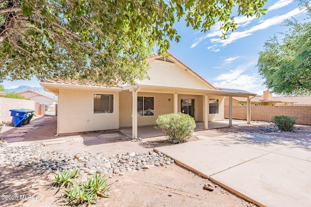 back of house with a patio