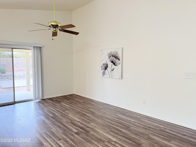 empty room featuring dark hardwood / wood-style flooring, vaulted ceiling, and ceiling fan