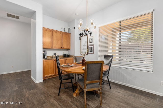 dining room with a chandelier and dark hardwood / wood-style floors