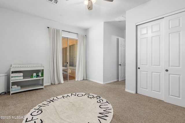 bedroom featuring ceiling fan, light colored carpet, and a closet