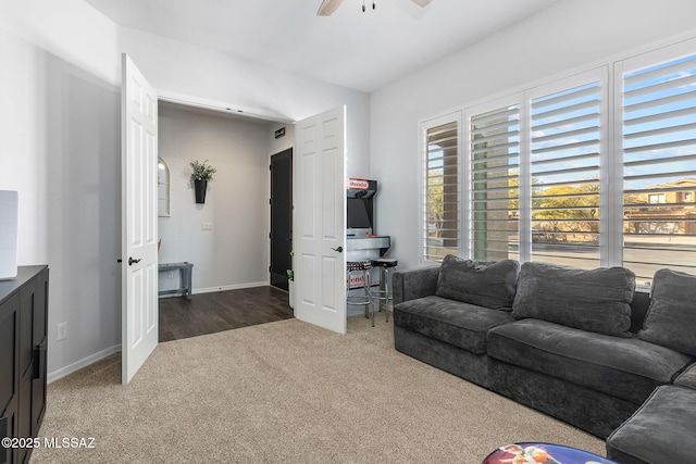 carpeted living room featuring ceiling fan