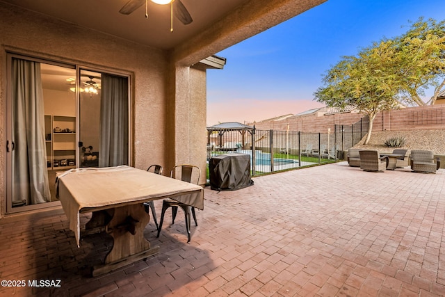 patio terrace at dusk with a gazebo and ceiling fan