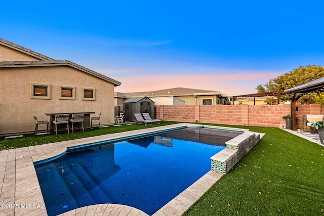 pool at dusk with a shed and a lawn