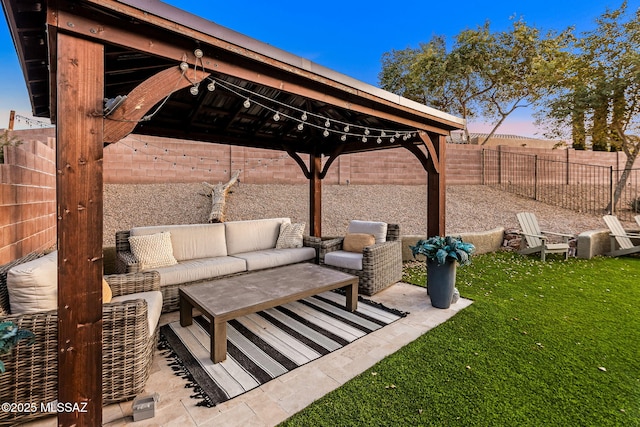 patio terrace at dusk featuring a yard and an outdoor hangout area