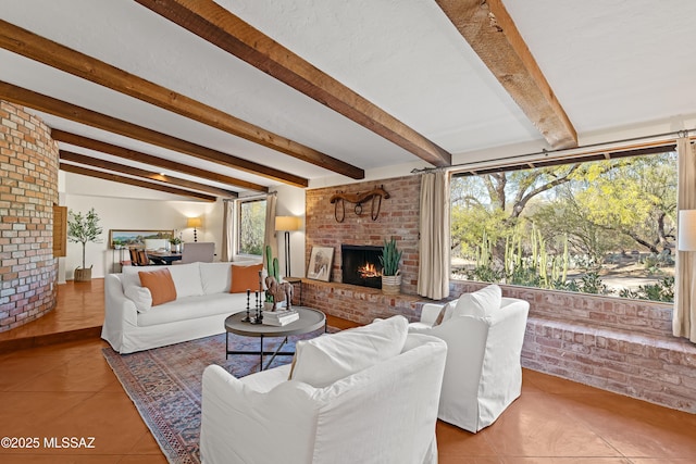 tiled living room featuring a healthy amount of sunlight, a fireplace, and beamed ceiling