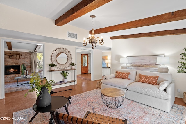 living room with a brick fireplace, light tile patterned floors, beam ceiling, and an inviting chandelier