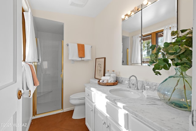 bathroom with walk in shower, vanity, tile patterned flooring, and toilet