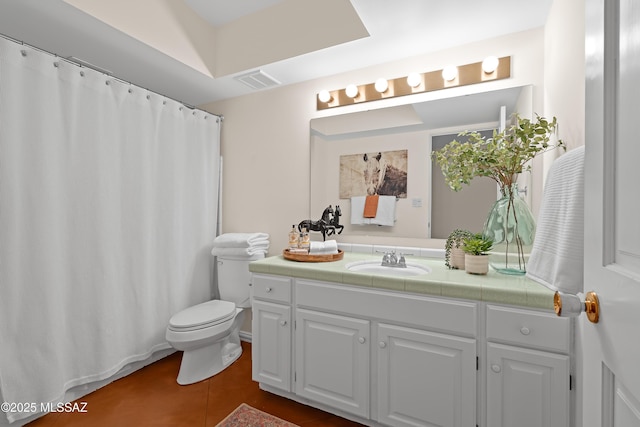 bathroom with toilet, tile patterned flooring, and vanity