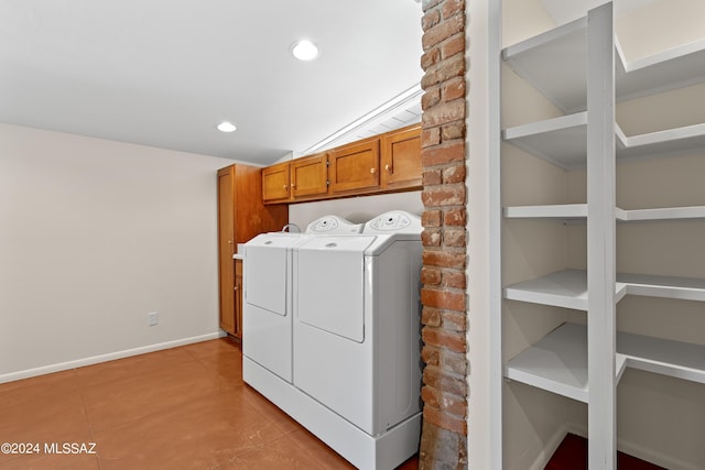 washroom with light tile patterned flooring, cabinets, washer and dryer, and built in shelves