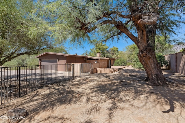 exterior space featuring a garage and an outdoor structure