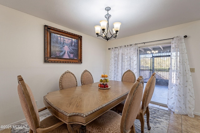 dining room with light tile patterned floors and an inviting chandelier