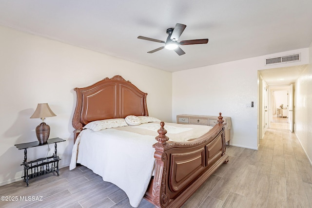 bedroom with light hardwood / wood-style flooring and ceiling fan