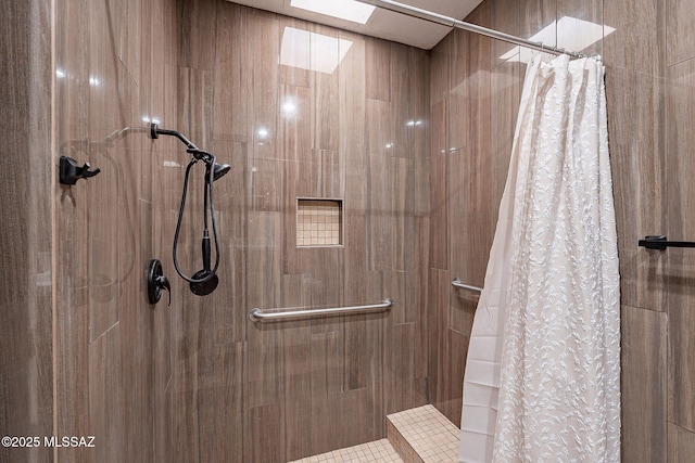 bathroom with a shower with curtain and a skylight