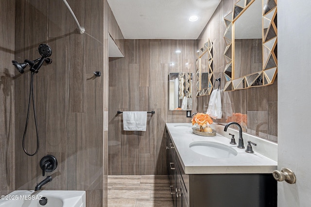 bathroom featuring vanity and tiled shower / bath combo