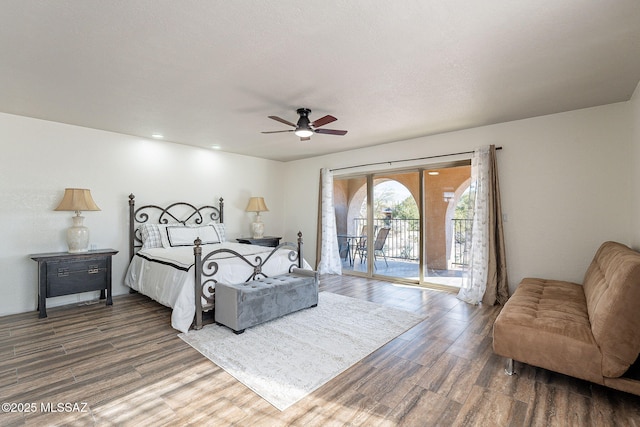 bedroom featuring ceiling fan, wood-type flooring, and access to outside