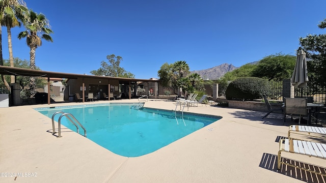 view of pool with a mountain view and a patio area