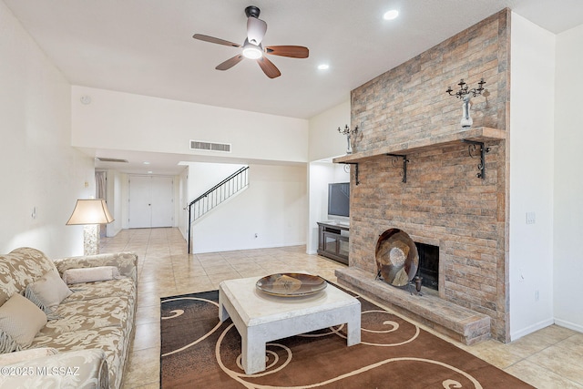 living room with ceiling fan and light tile patterned flooring