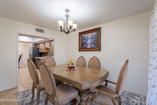 tiled dining area with an inviting chandelier