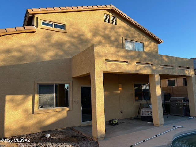 back of house with a patio