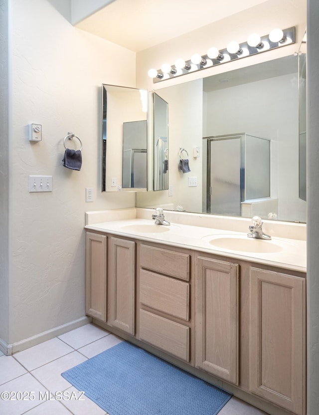 bathroom featuring vanity, tile patterned flooring, and a shower with shower door