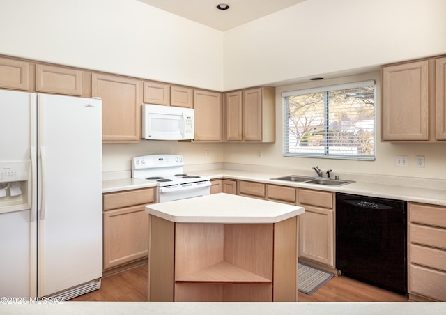 kitchen with sink, a kitchen island, white appliances, and light brown cabinetry