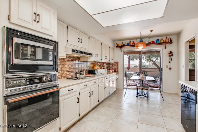 kitchen featuring white cabinetry, black oven, and backsplash