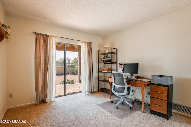 office area with light carpet and a textured ceiling