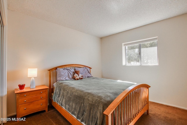 carpeted bedroom with a textured ceiling