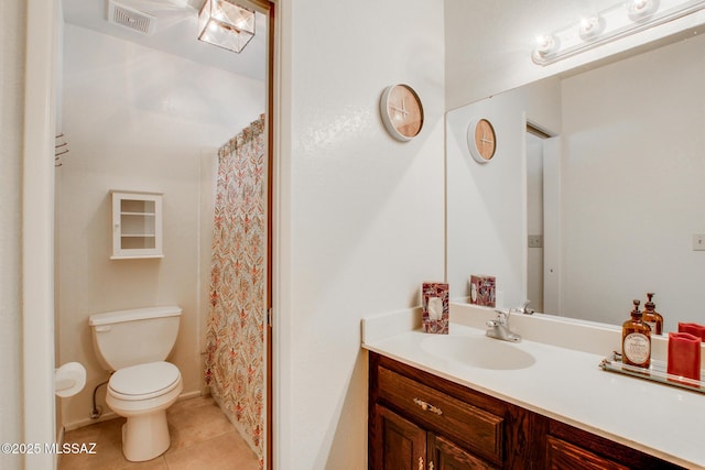 bathroom featuring tile patterned floors, vanity, and toilet